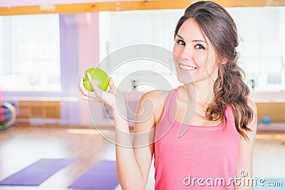 Beautiful caucasian woman after fitness exercise holding green aple Stock Photo