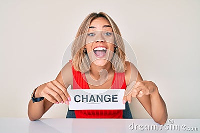 Beautiful caucasian woman holding change banner smiling and laughing hard out loud because funny crazy joke Stock Photo