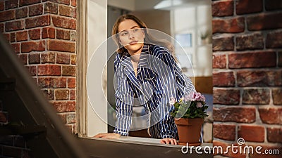 Beautiful Caucasian Woman Opening the Curtains of her Bedroom Window and Enjoying the Fresh Morning Stock Photo