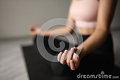 Beautiful caucasian woman in sportswear practices yoga on the mat at home. close hand Stock Photo