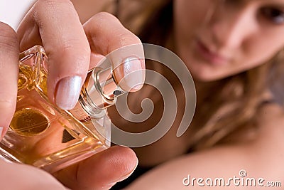 Beautiful caucasian woman spraying parfum Stock Photo