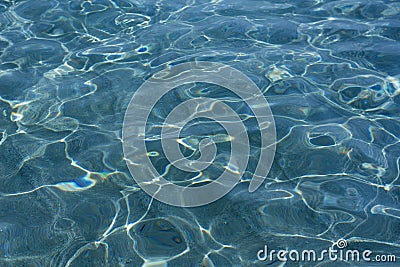 Bright caustics on water surface in blue sea Stock Photo