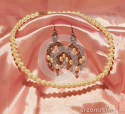 Beautiful chandelier earrings and pearl necklace Stock Photo