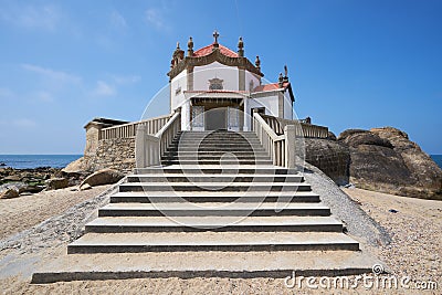 Beautiful chapel on the beach Capela do Senhor da Pedra in Miramar, in Portugal Stock Photo