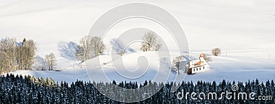Beautiful chapel in lovely rural countryside on snowy winter sunrise seen from above. Weitnau, Allgau, Bavaria, Germany. Stock Photo