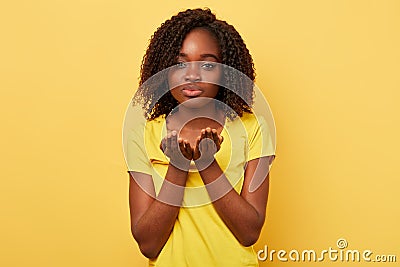 Beautiful charming african american woman blowing a kiss with hand on air Stock Photo