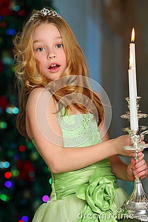 Beautiful charming pretty blond child-girl on the background of a New Year tree Stock Photo