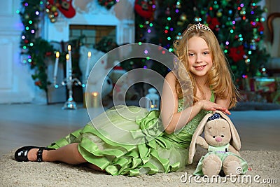 Pretty blond child-girl on the background of a New Year tree Stock Photo