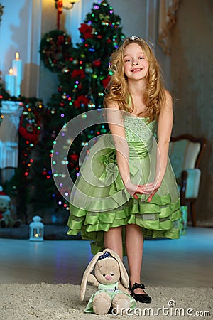 Pretty blond child-girl on the background of a New Year tree Stock Photo