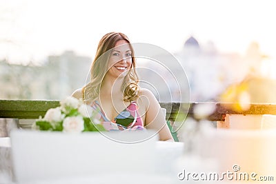 Beautiful and charming smiling woman sitting outdoor Stock Photo