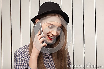 Beautiful, cheerful, joyful,happy girl in shirt and hat talking on the phone Stock Photo