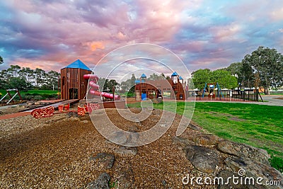 Childrenâ€™s park playground in Suburban Melbourne Victoria Australia. Lovely green grass and nice sunset colours in the sky Stock Photo