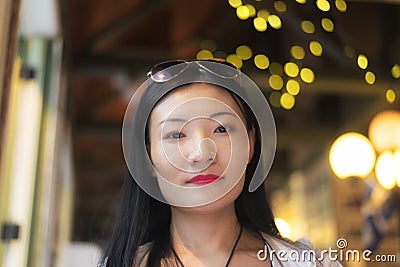 Beautiful Chinese woman smiling indoors Stock Photo