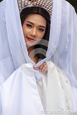 Beautiful Chinese woman white dress traditional, Beautiful and belligerent face; asian you woman in Chinese dress Stock Photo