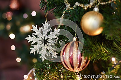 Beautiful Christmas decor, New year toys, glow in the dark garland. Christmas tree decorated with toys and balloons. Festive mood Stock Photo