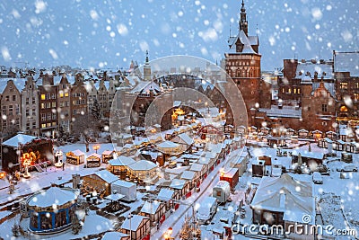 Beautiful Christmas fair in the old town of Gdansk at snowy dawn, Poland Stock Photo