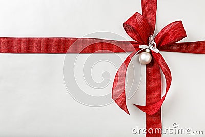 Beautiful Christmas gift present with bright red bow and silver wrapping paper background border Stock Photo