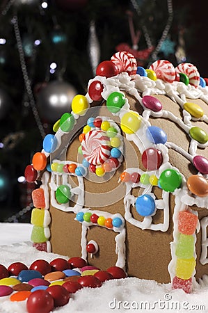 Beautiful Christmas table setting in front of Christmas Tree, featuring a gingerbread house Stock Photo