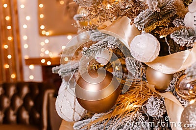 Beautiful Christmas tree is close. Golden Christmas. golden and white balls on Christmas tree branches Stock Photo
