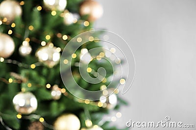 Beautiful Christmas tree with lights against grey background, blurred view Stock Photo