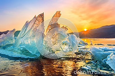 Beautiful chunk of Ice at Sunrise in winter. Stock Photo