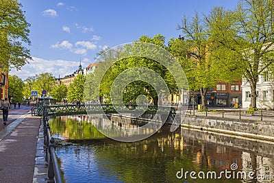 Beautiful city landscape view with small bridge decorated with colorful flowers on its sides. Editorial Stock Photo