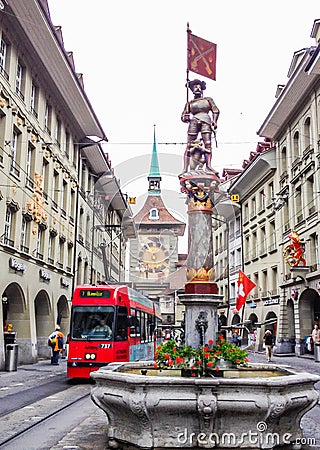 Beautiful City Street View of the colorful medieval Marksman statue on top of elaborate fountain in Bern, Switzerland. Editorial Stock Photo