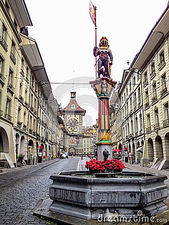 Beautiful City Street View of the colorful medieval Zahringen statue on top of elaborate fountain in Bern, Switzerland. Stock Photo