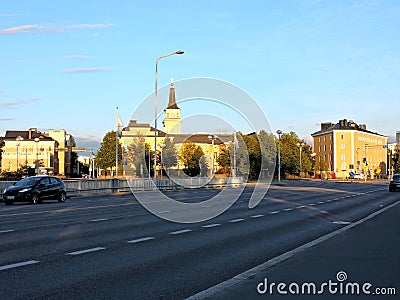 View of church, road in sunset sun in summer Oulu, Finland Editorial Stock Photo