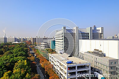 The beautiful cityscape with modern factory buildings and colorful woods around,Osaka,Japan Stock Photo