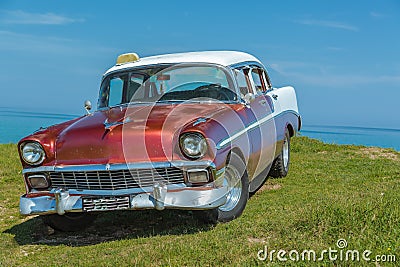 Beautiful classic retro car parked on green cliff Stock Photo