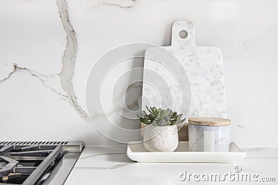 A beautiful closeup of a custom designed kitchen, with marble looking quartz countertop and backsplash Stock Photo