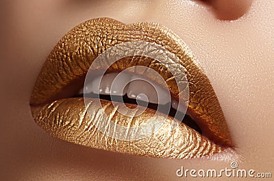 Beautiful closeup with female plump lips with gold color makeup. Fashion celebrate make-up, glitter cosmetic Stock Photo