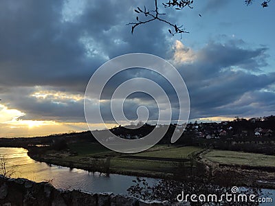 beautiful clouds in the form of a paw over the narrow sources of the river Stock Photo