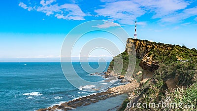 Beautiful Clouds Surrounding the Telecommunications Tower on top of the Cliff in Yehliu Geopark, Taiwan Stock Photo