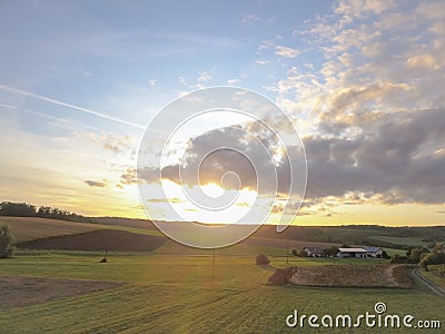 Beautiful cloudscape over the fields and farmlands near a village Stock Photo