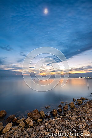 Beautiful coast sea with the moon at twilight Stock Photo