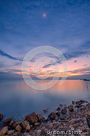 Beautiful coast sea with the moon at twilight Stock Photo