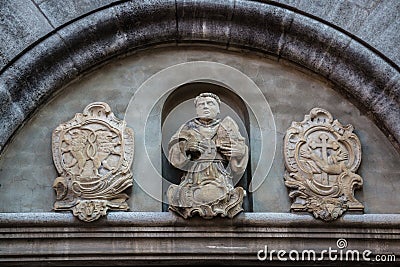 Beautiful coat of arms and statue on a historical old building Stock Photo