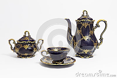 Beautiful cobalt blue colored vintage porcelain tea set with gold ornament Stock Photo