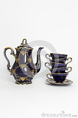 Beautiful cobalt blue colored vintage porcelain tea set with gold ornament Stock Photo