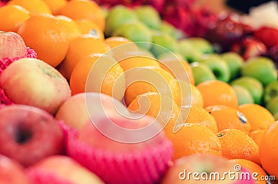 Beautiful color combination, variety of fresh raw fruits background display at market stall Stock Photo