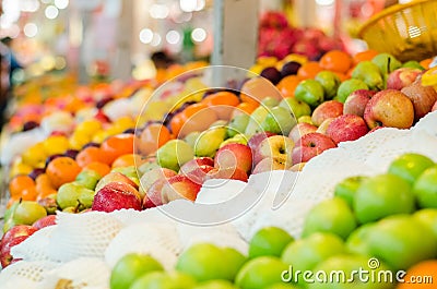 Beautiful color combination, variety of fresh raw fruits background display at market stall Stock Photo