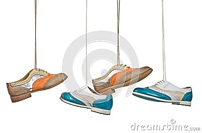 Beautiful color woman shoes hanging on laces with isolated white Stock Photo