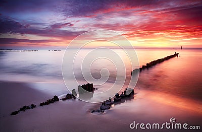 Beautiful colored clouds over the ocean at the beach at sunset Stock Photo