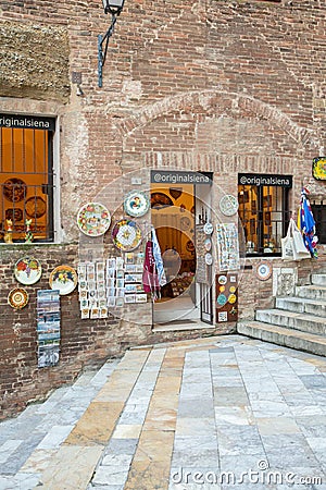 Beautiful colored and medieval street in the old town of Siena, Italy Editorial Stock Photo