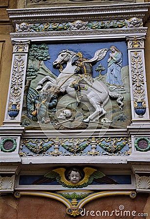 A beautiful colored terracotta sculpture, depicting Saint George slaying the dragon, adorns a wall of the villa museum of Frederic Editorial Stock Photo