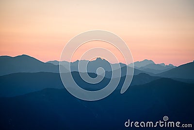 A beautiful, colorful, abstract mountain scenery in sunrise. Minimalist landscape of mountains in morning in blue tones. Stock Photo