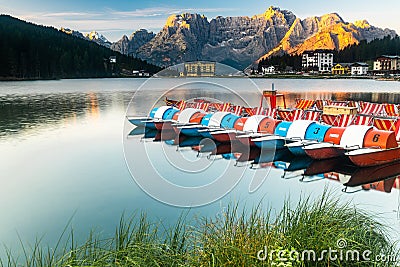 Beautiful Colorful Boats at Lake Misurina in Italian Dolomites at Sunrise Stock Photo