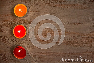 Colorful candles on the wooden boards. Stock Photo